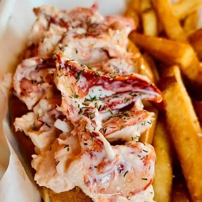The Shack's signature lobster roll — chunks of PEI lobster with fresh dill on a warm buttered brioche-style bun, with crisp fries
